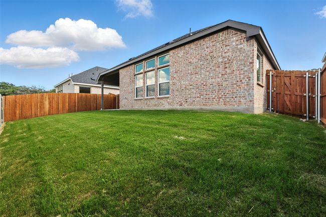Back of house with brick siding and a fenced backyard | Image 32