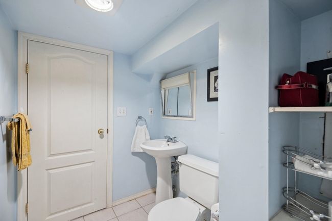 Half bath with toilet, baseboards, and tile patterned flooring | Image 21