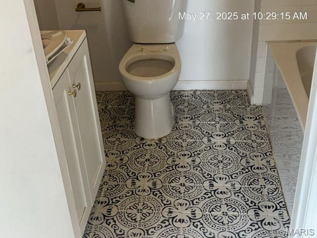 Full bath featuring tile patterned flooring, toilet, vanity, and baseboards | Image 9