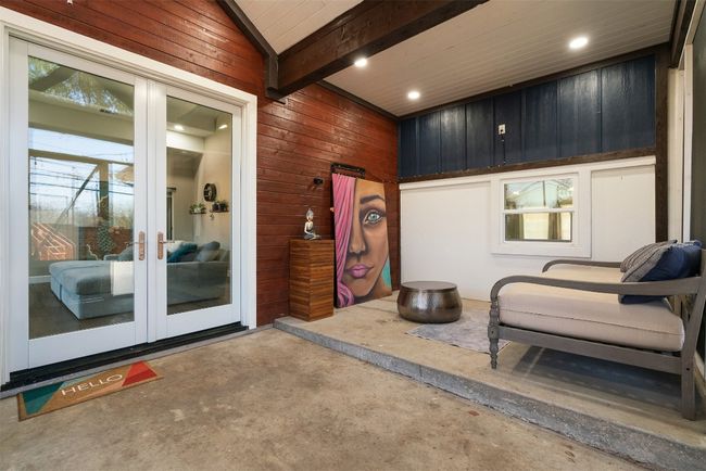 The screened-in patio brings the outdoors in, with walls of windows that flood the space with light, making it a perfect place to enjoy a cup of coffee or relax with a good book | Image 25