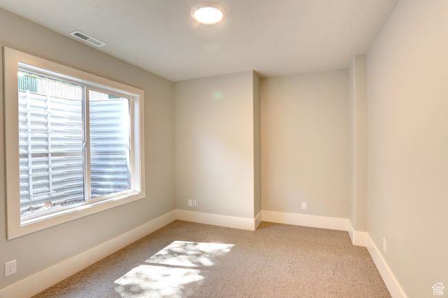 Unfurnished room with light colored carpet and baseboards | Image 35