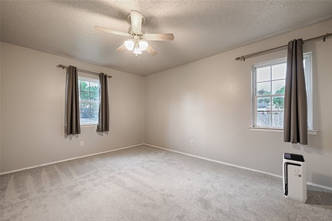 Spacious primary bedroom featuring new carpet and great natural light. | Image 13