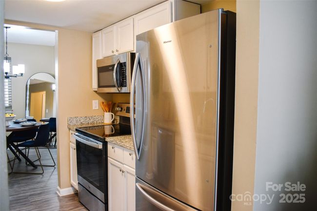 Kitchen features stainless appliances. | Image 7