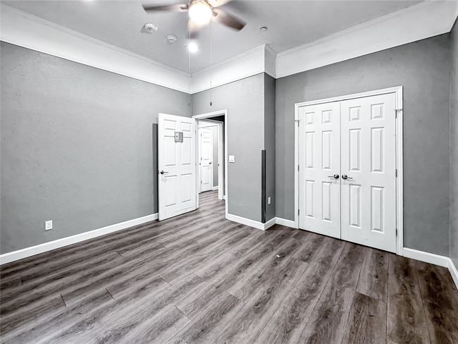 Unfurnished bedroom featuring wood finished floors, a closet, and ceiling fan | Image 20