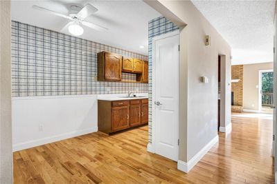 View from the foyer. Kitchen pantry door shown. Gotta love those hardwood floors! | Image 3