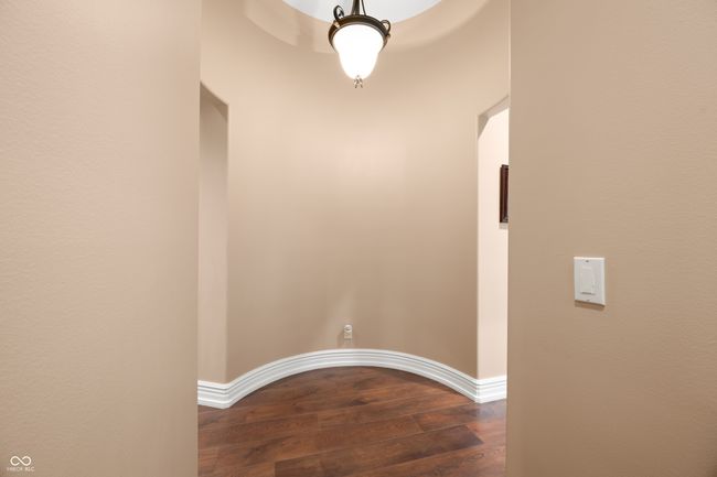 hall featuring dark wood finished floors and baseboards | Image 37