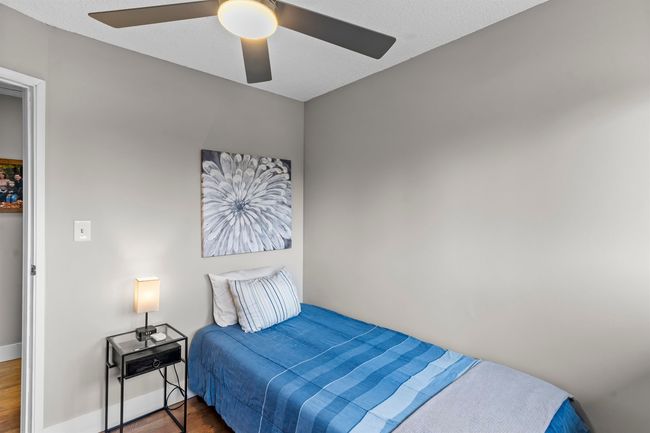 Bedroom featuring baseboards, a ceiling fan, and wood finished floors | Image 14