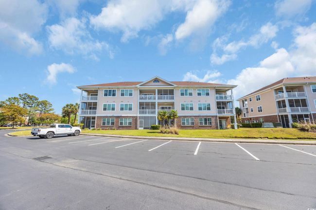 View of building exterior featuring uncovered parking | Image 28