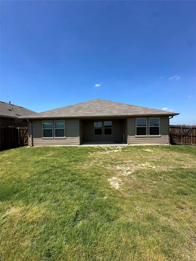 Rear view of property with a yard and a fenced backyard | Image 26