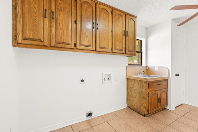Laundry room goes out into garage | Image 12