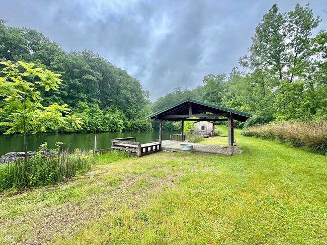 view of green lawn with a boat dock, a water view, and a view of trees | Image 28