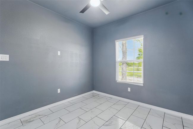 Unfurnished room with baseboards, tile finish floor, and ceiling fan | Image 22