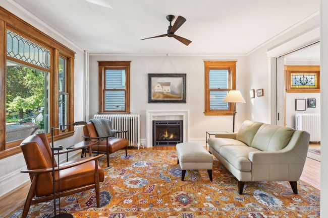 Two side windows added to the living room provide so much bright light to this cozy room. High ceilings & new gas fireplace with limestone mantel make this the perfect gathering room. | Image 10