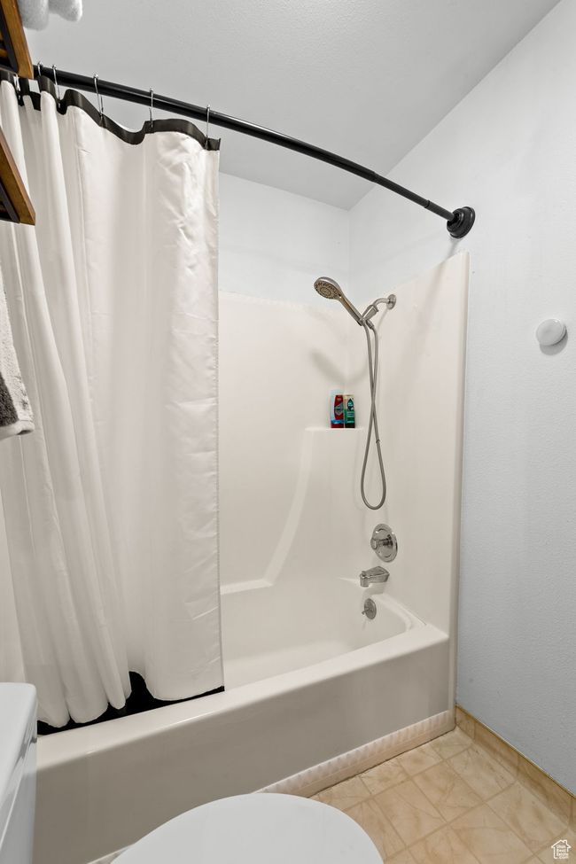 Bathroom featuring shower / bath combo, toilet, and tile patterned floors | Image 17