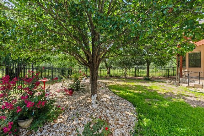 View of fenced backyard | Image 33