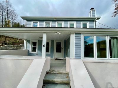 Doorway to property featuring a porch | Image 2