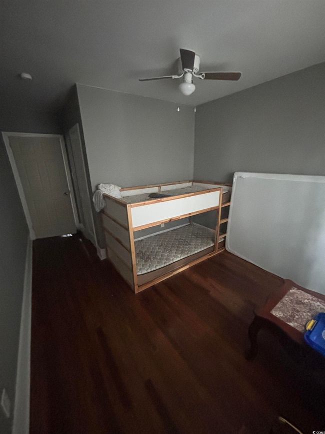Bedroom with wood finished floors and ceiling fan | Image 19