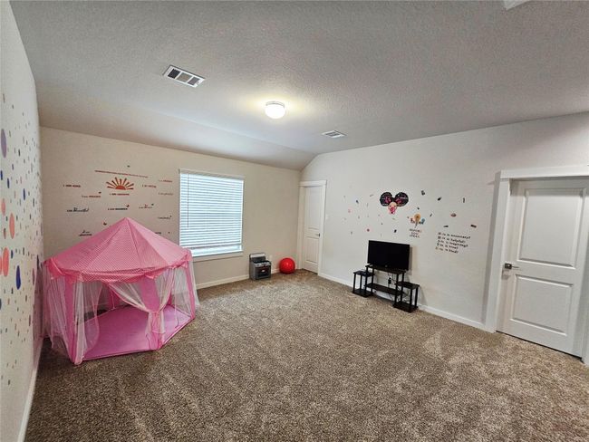 Upstairs gameroom or second family area with supply closet | Image 12