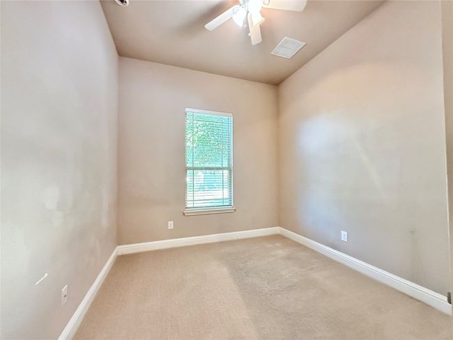 Unfurnished room featuring light carpet and a ceiling fan | Image 37