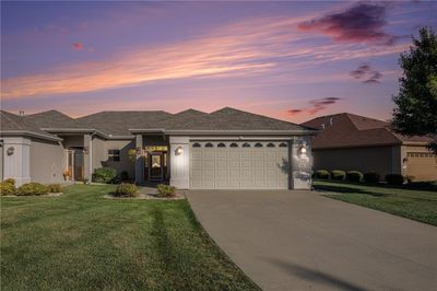 View of front of home with a lawn and a garage | Image 1