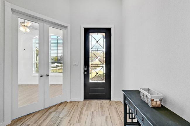 Glass French doors add an elegant touch to the home office, while still maintaining an open feel for the space. | Image 17