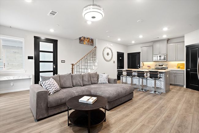Living room featuring stairway, light wood-style floors, and recessed lighting | Image 8