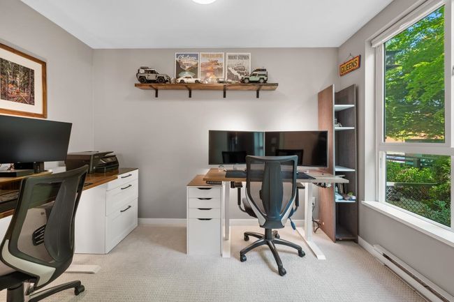 Home office with a baseboard heating unit and light colored carpet | Image 32