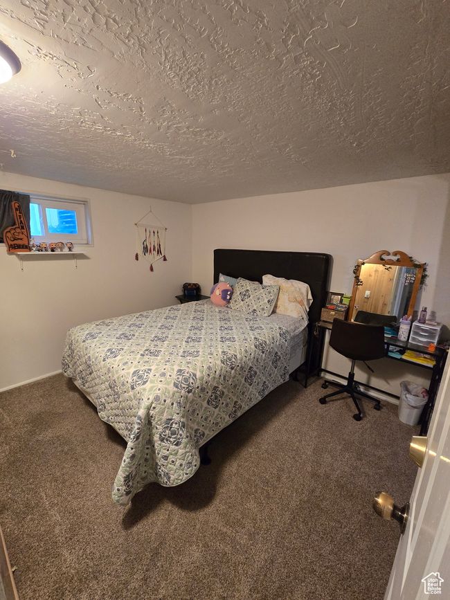 Carpeted bedroom featuring a textured ceiling | Image 36