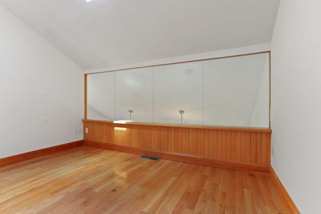 Unfurnished room with light wood-style floors, baseboards, and lofted ceiling | Image 23