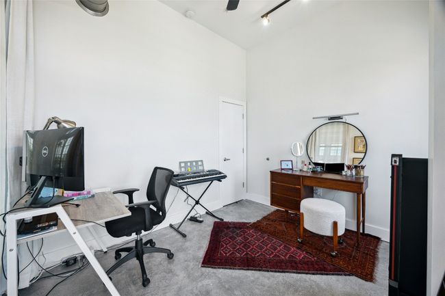 Home office featuring baseboards and a towering ceiling | Image 19