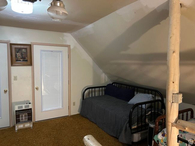 Carpeted bedroom featuring heating unit and vaulted ceiling | Image 26