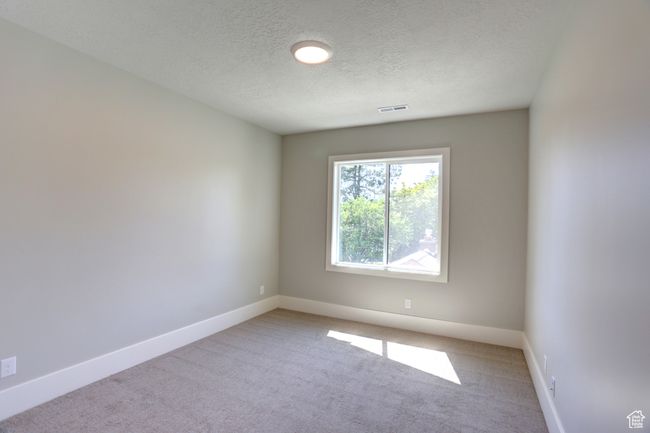 Spare room featuring carpet floors and a textured ceiling | Image 25