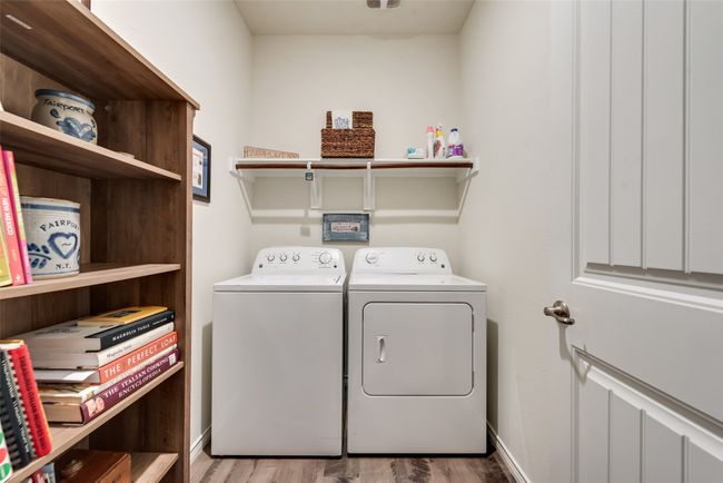 Washroom with washing machine and dryer and wood finished floors | Image 26