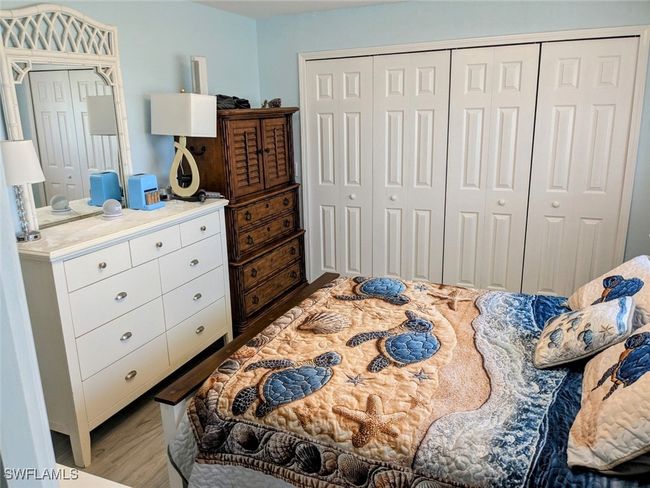 Bedroom with a closet and wood finished floors | Image 27