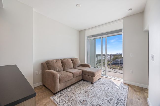 Living area featuring baseboards, a wall of windows, and light wood-style floors | Image 9