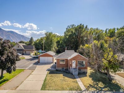 View of front of house with a garage, a front yard, and a mountain view | Image 1