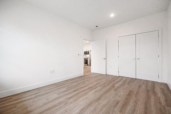 Unfurnished bedroom featuring wood finished floors, baseboards, a closet, and recessed lighting | Image 40