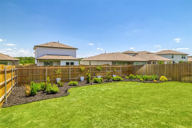 View of the back yard with custom landscaping | Image 26