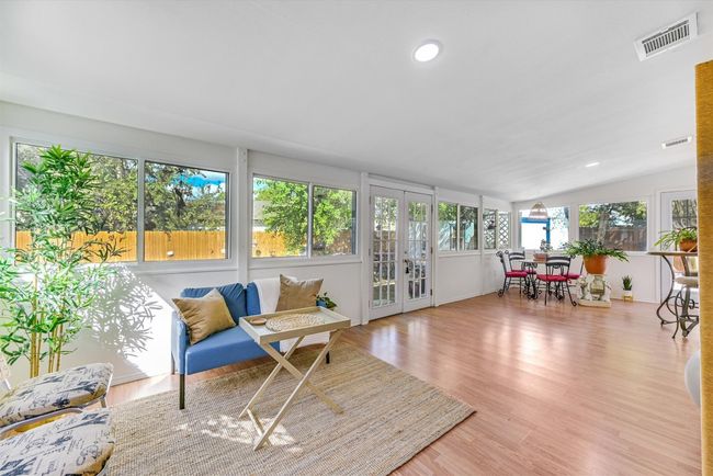 Flooded with natural light, the oversized sunroom stretches across the back of the home, an ideal flex space for lounging, dining, working, or creating | Image 9