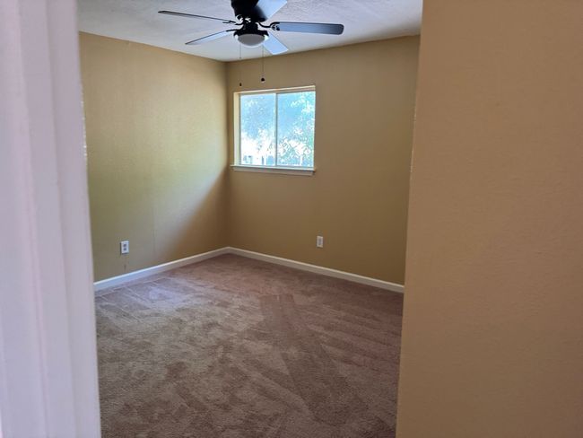 Empty room featuring a ceiling fan and carpet | Image 12