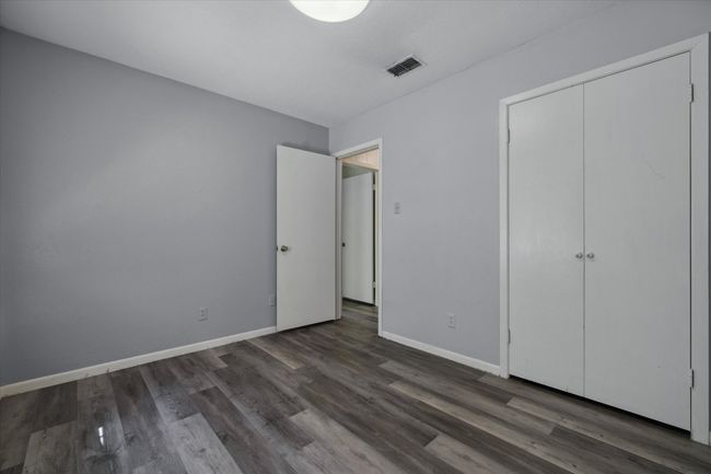 Unfurnished bedroom featuring wood finished floors and a closet | Image 13