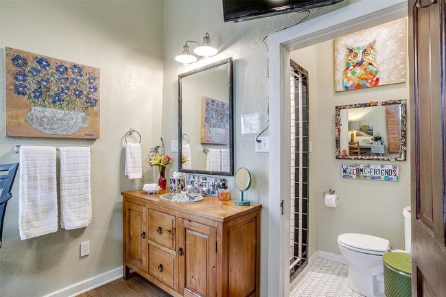 Kason's Cove private bathroom has a lovely colorful custom shower with vanity made from antique pine dresser and a sink purchased in Mexico. | Image 37