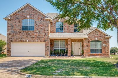 View of front property featuring a front yard and a garage | Image 2