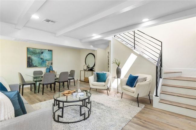 The modern transitional interior impresses with a desirable open floorplan, main-floor primary suite, and plentiful natural light. | Image 6