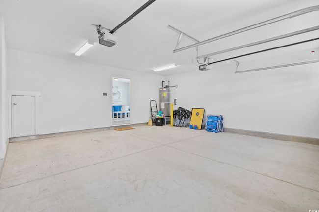 Garage with water heater and a garage door opener | Image 34