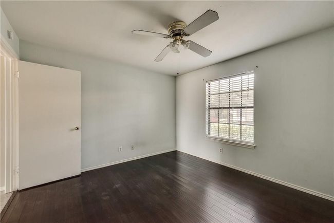 Unfurnished room with hardwood / wood-style floors and ceiling fan | Image 11