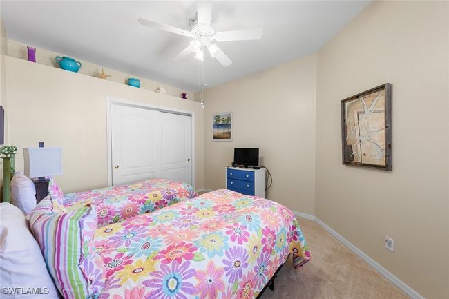 Bedroom with a ceiling fan, baseboards, carpet floors, and a closet | Image 23