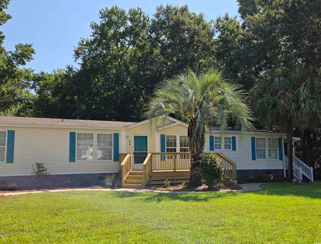 Manufactured / mobile home with crawl space, a front yard, a wooden deck, and stairway | Image 4