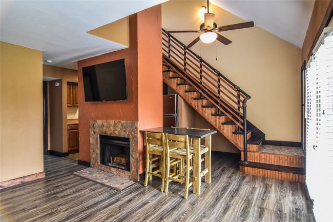 Main living area with wood burning fireplace. | Image 5