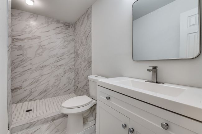Bathroom featuring a shower stall, marble finish floor, toilet, and vanity | Image 15